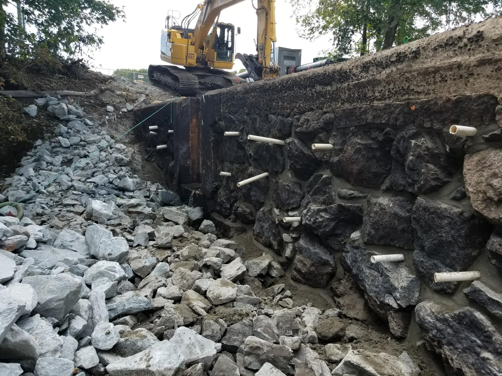 Re-pointing downstream face of dam. Installation of injection ports.