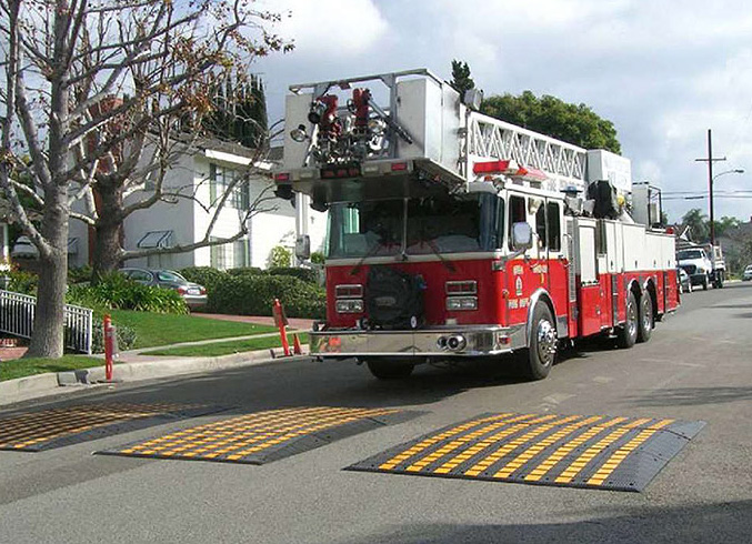 Firetruck approaches speed cushions on the roadway